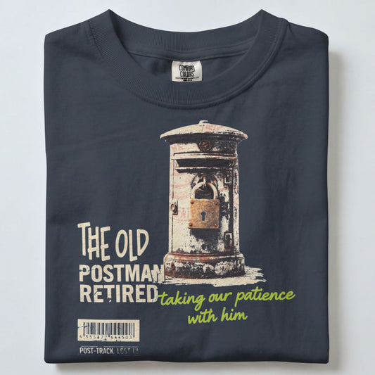 A folded dark navy blue t-shirt with a graphic print of a vintage mail box and the text 'THE OLD POSTMAN RETIRED taking our patience with him'.