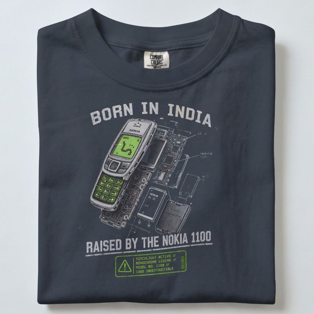 BORN IN INDIA RAISED BY THE NOKIA 1100 UNISEX TSHIRT